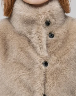 Manteau en fausse fourrure reversible beige et noir